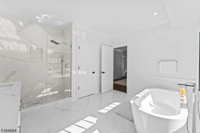 a living room with furniture a potted plant and wooden floor