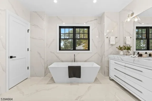 a bathroom with a tub sink and shower