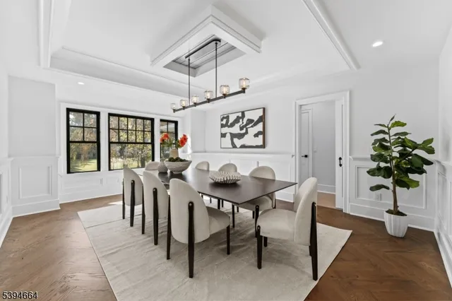 a view of a dining room with furniture and chandelier