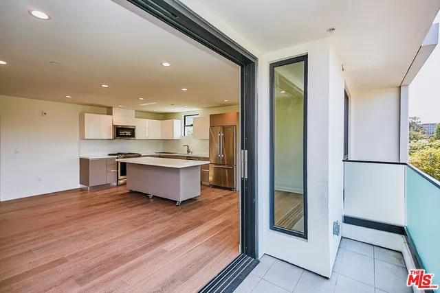 a large kitchen with a large window and stainless steel appliances