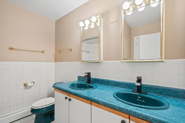 a bathroom with a sink a toilet and mirror