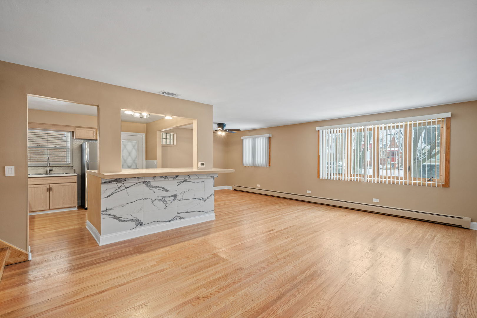 2737 Spruce Street River Grove, IL 60171 - Photo 2 of 20 an empty room with wooden floor and windows