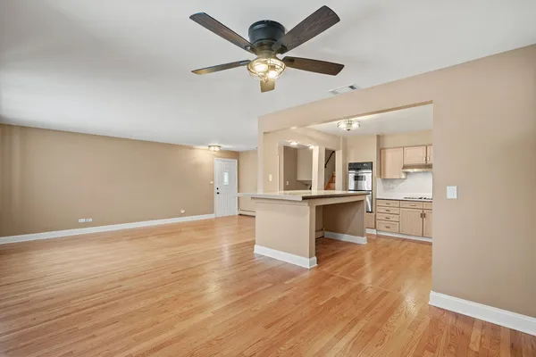 a view of a kitchen with a sink and dishwasher a refrigerator with wooden floor