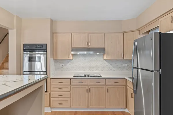 a kitchen with appliances cabinets and a counter top space