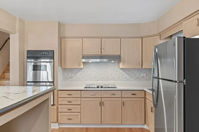 a kitchen with appliances cabinets and a counter top space