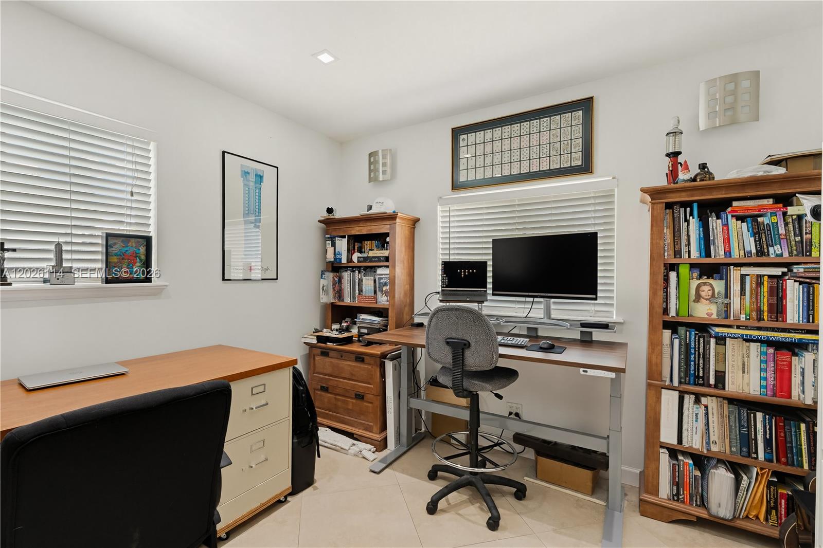 9641 Southwest 66th Street Miami, FL 33173 - Photo 33 of 57 a view of a workspace with furniture and a bookshelf