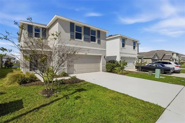 a front view of a house with a yard and garage