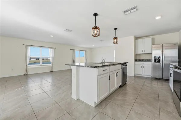 a large kitchen with cabinets and stainless steel appliances