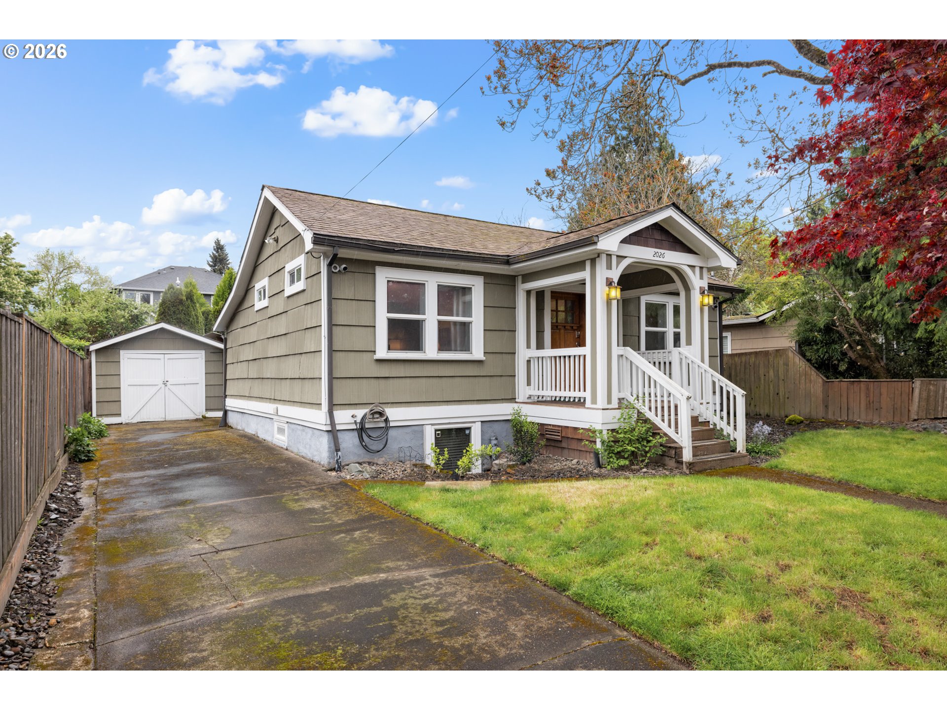 2026 Southeast Insley Street Portland, OR 97202 - Photo 2 of 32 a front view of a house with a yard