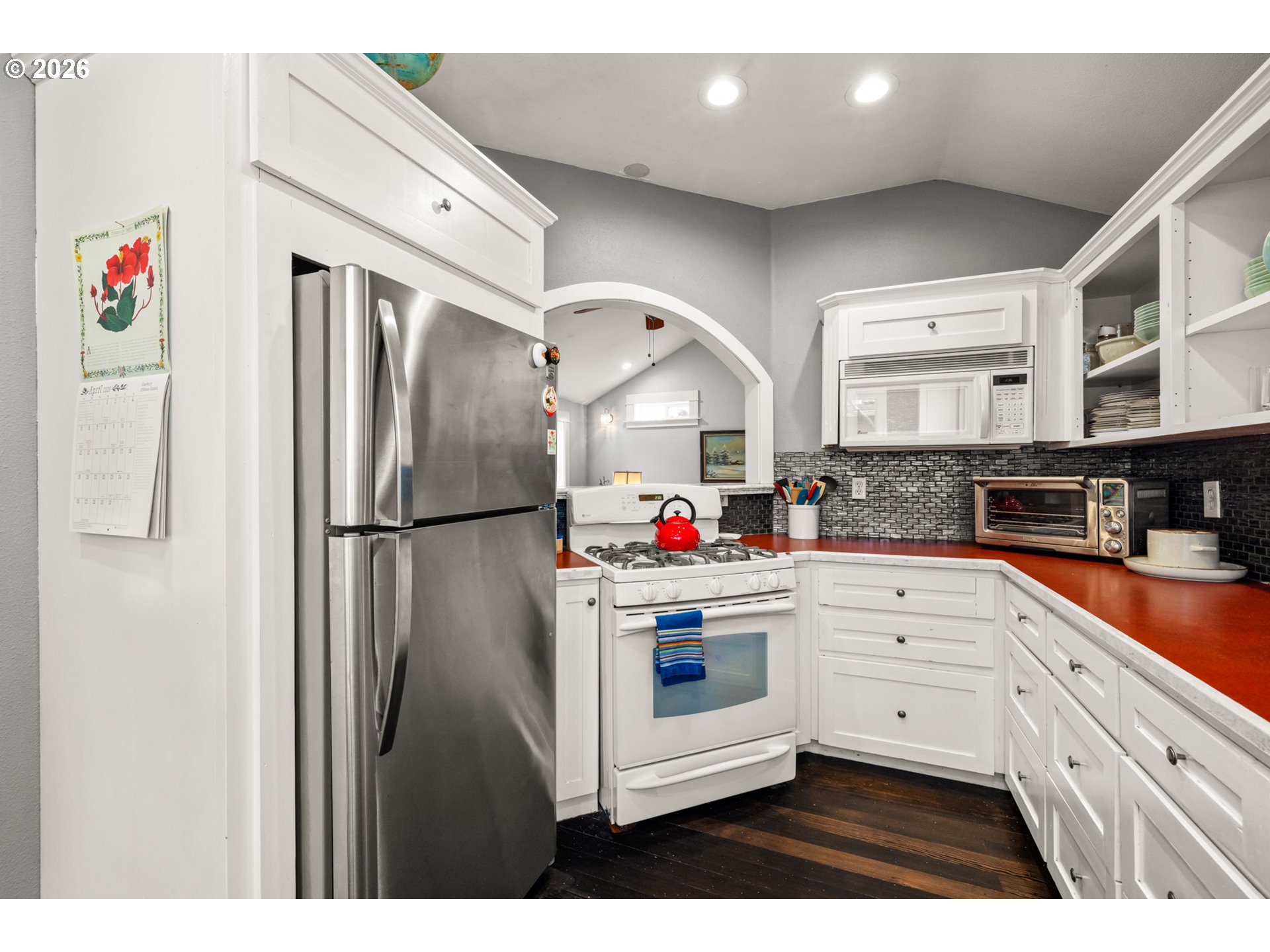 2026 Southeast Insley Street Portland, OR 97202 - Photo 5 of 32 a kitchen with stainless steel appliances a refrigerator sink and cabinets