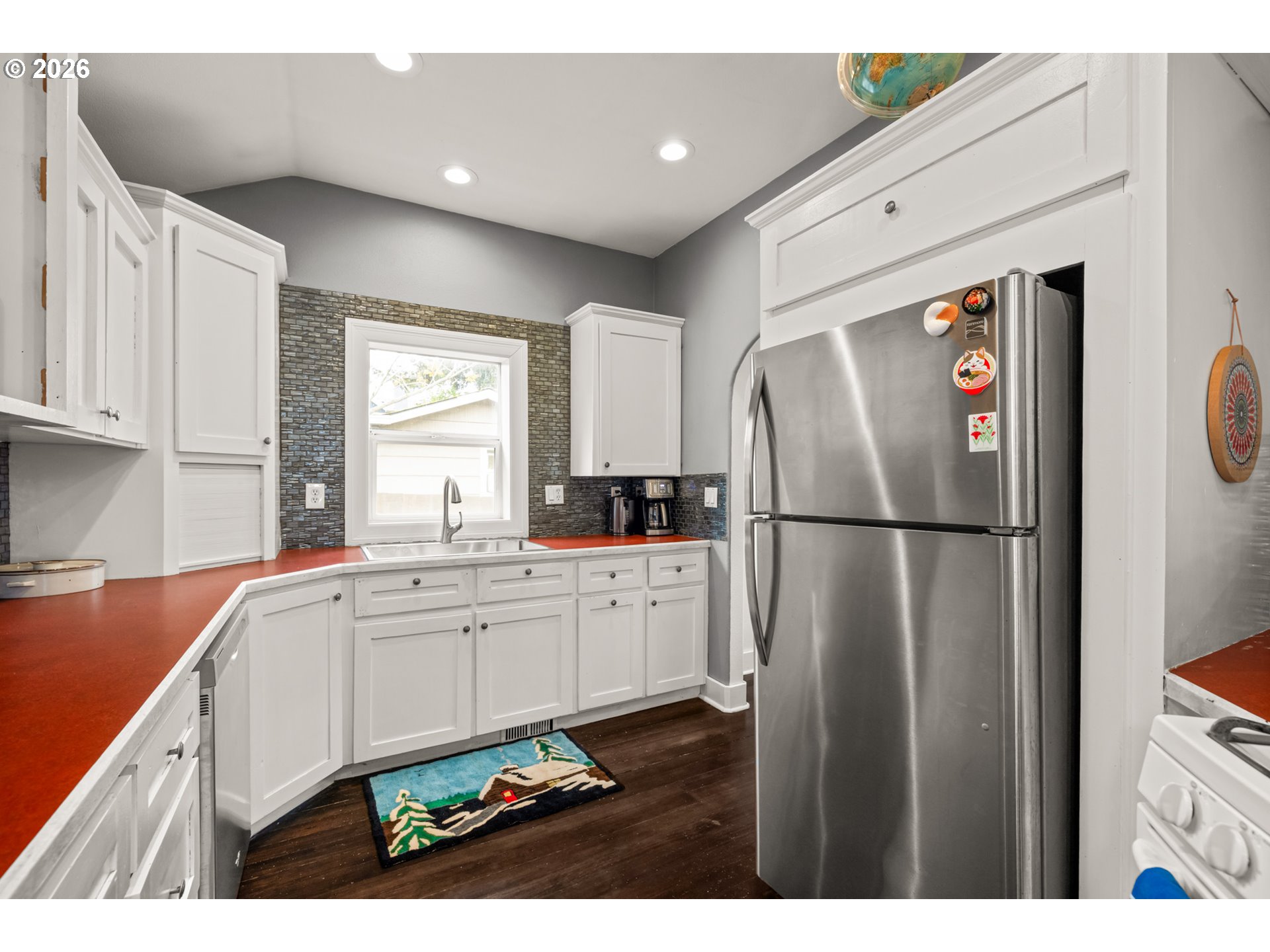 2026 Southeast Insley Street Portland, OR 97202 - Photo 6 of 32 a kitchen with a refrigerator a sink and cabinets