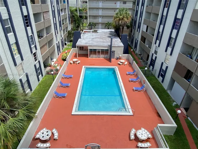 a view of a park with slide and a tree