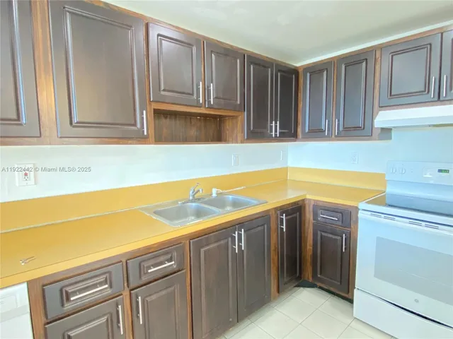 a kitchen with a refrigerator and a sink