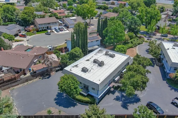 an aerial view of a house with table and chairs