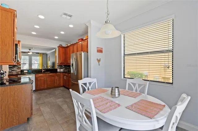 a large kitchen with a table and chairs
