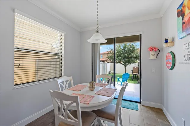 a dining room with furniture a chandelier and window