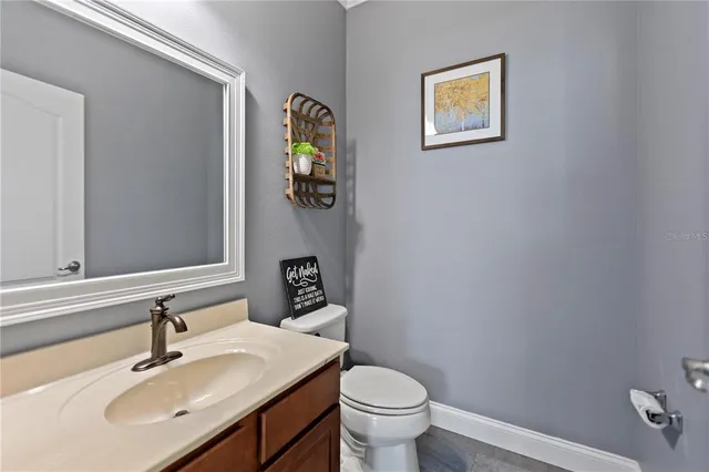 a bathroom with a sink mirror and toilet
