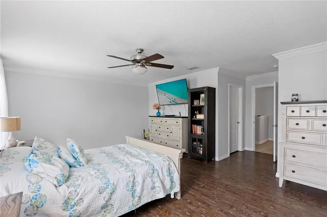 a bedroom with a bed and a television