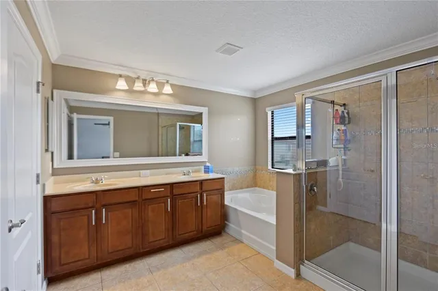 a bathroom with a tub mirror and sink
