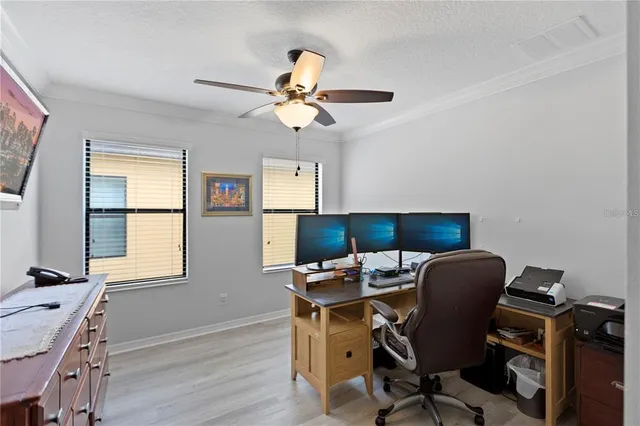 a view of workspace with wooden floor windows
