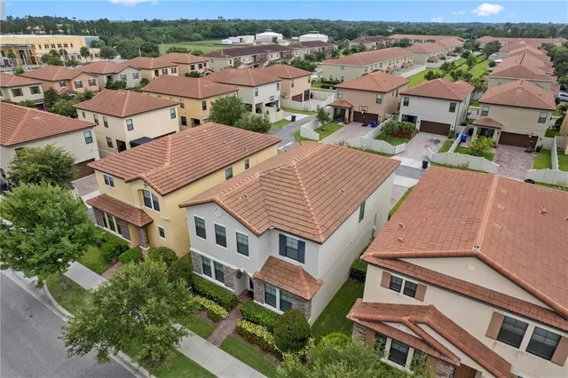 an aerial view of multiple houses with a yard
