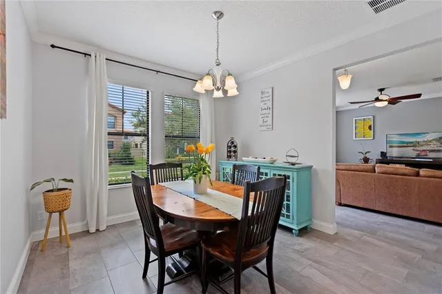 a dining room with furniture a window and wooden floor