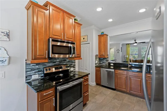 a kitchen with stainless steel appliances a stove sink and microwave