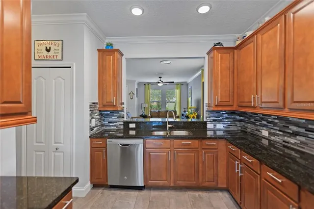 a kitchen with stainless steel appliances granite countertop a sink stove and cabinets