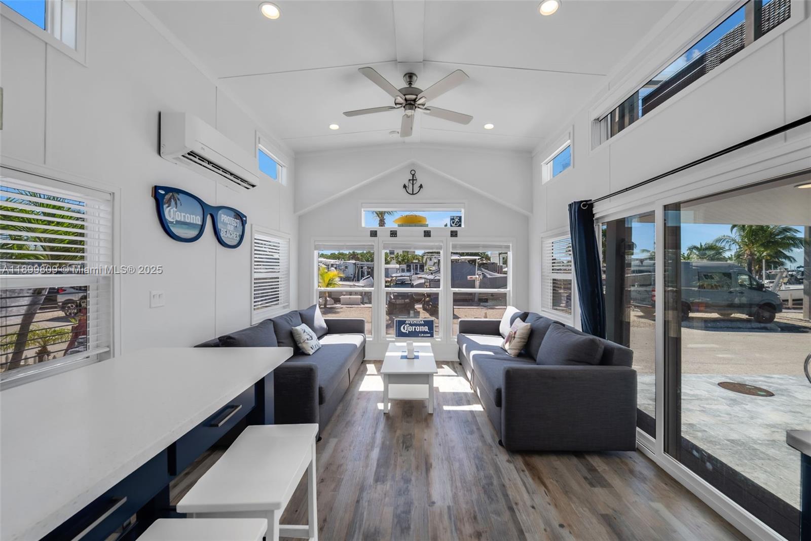 325 Calusa Street Key Largo, FL 33037 - Photo 14 of 26 a living room with fireplace furniture and a large window