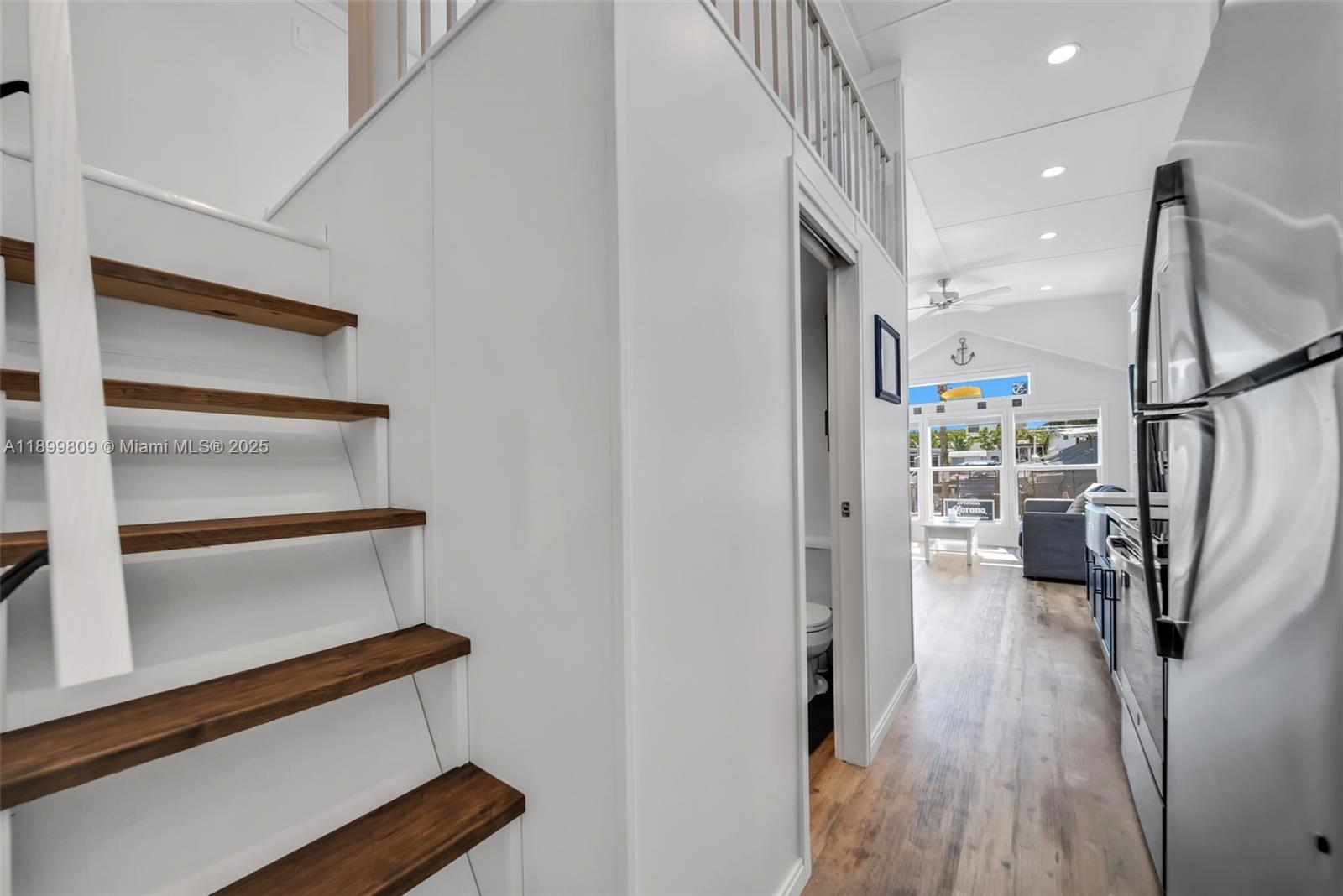 325 Calusa Street Key Largo, FL 33037 - Photo 21 of 26 a view of a hallway with wooden floor and staircase
