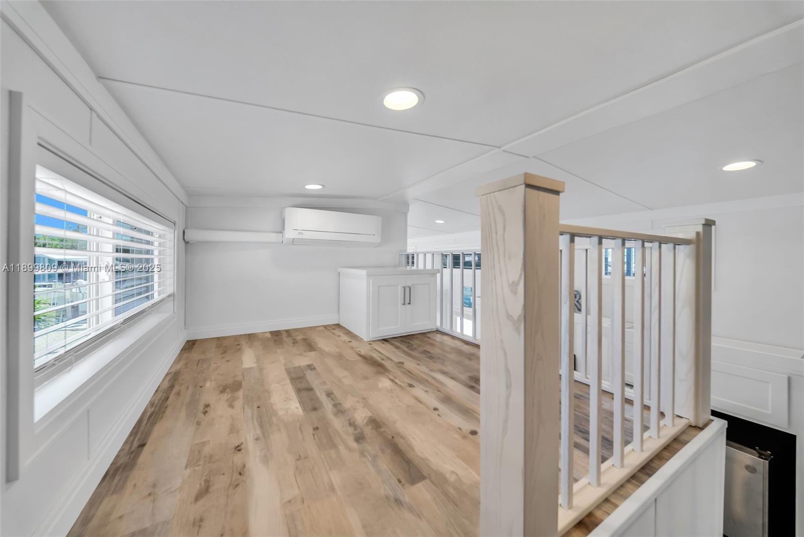 325 Calusa Street Key Largo, FL 33037 - Photo 23 of 26 a view of empty room with wooden floor and fan