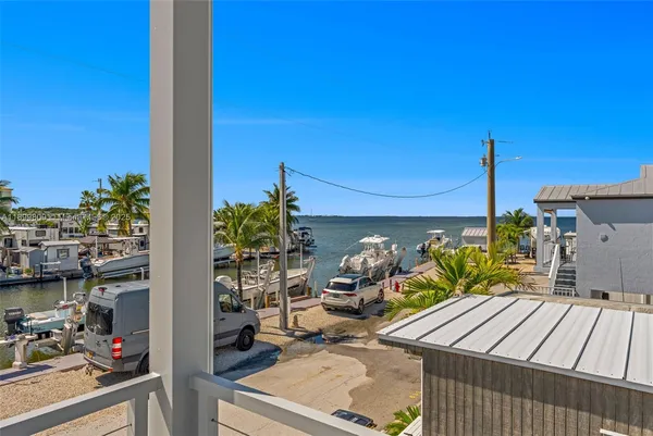 a view of a patio with a table and chairs and potted plants