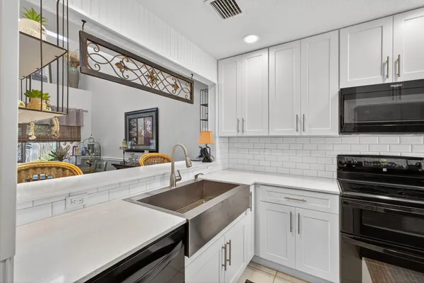 a kitchen with stainless steel appliances a refrigerator and a stove top oven