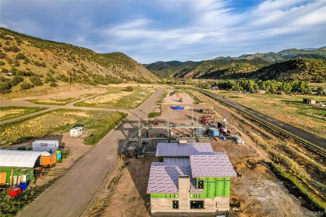 an aerial view of a lake with a mountain