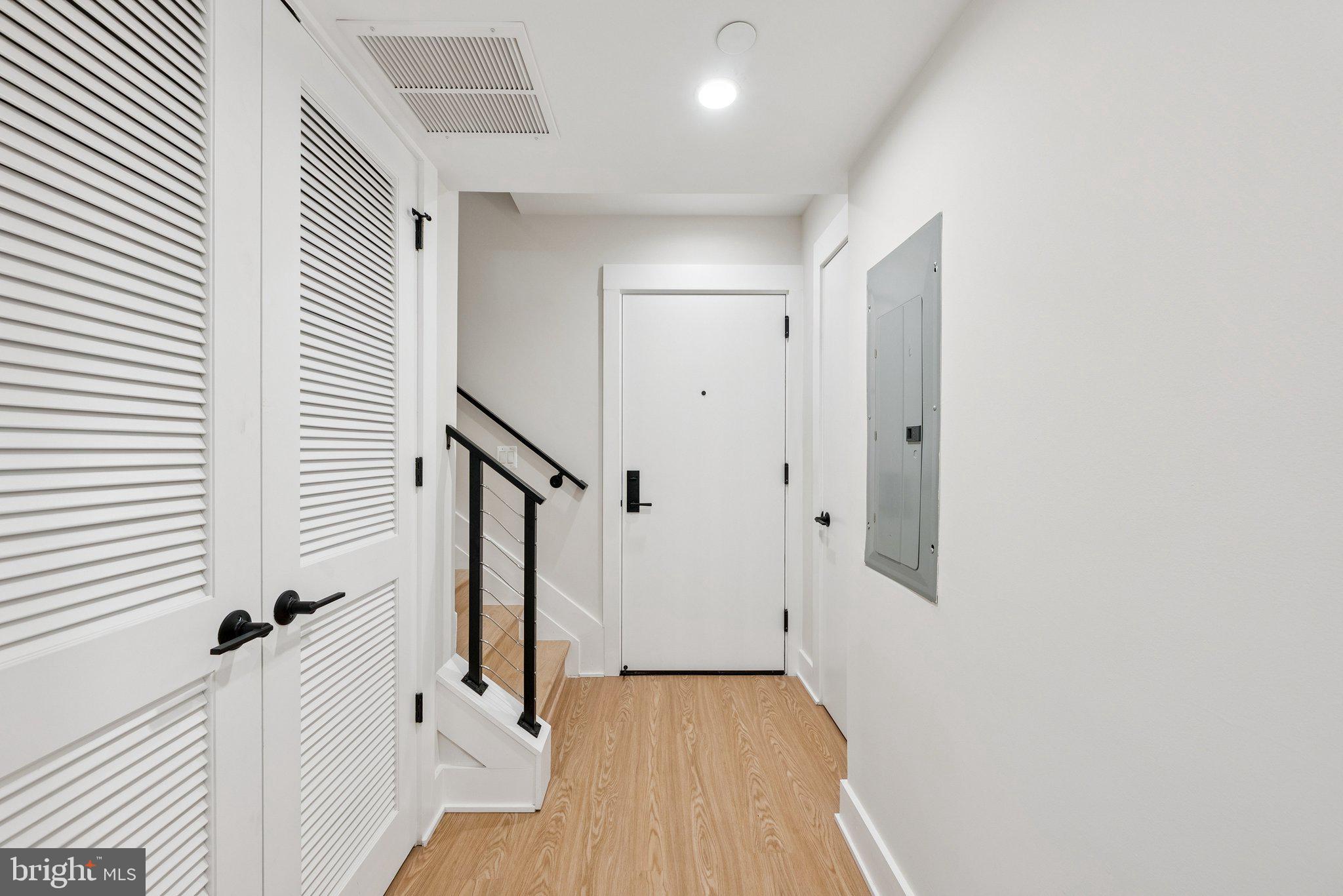 2134 Wisconsin Avenue Northwest, Unit 6 Washington, DC 20007 - Photo 11 of 43 a view of a hallway with wooden floor and staircase