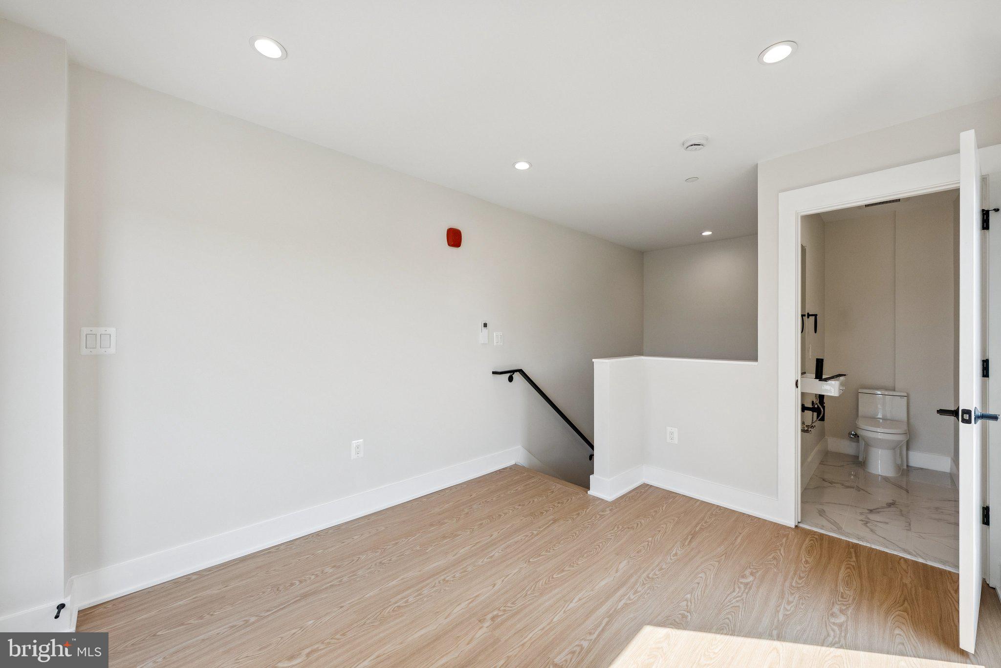 2134 Wisconsin Avenue Northwest, Unit 6 Washington, DC 20007 - Photo 13 of 40 wooden floor in an empty room with a window