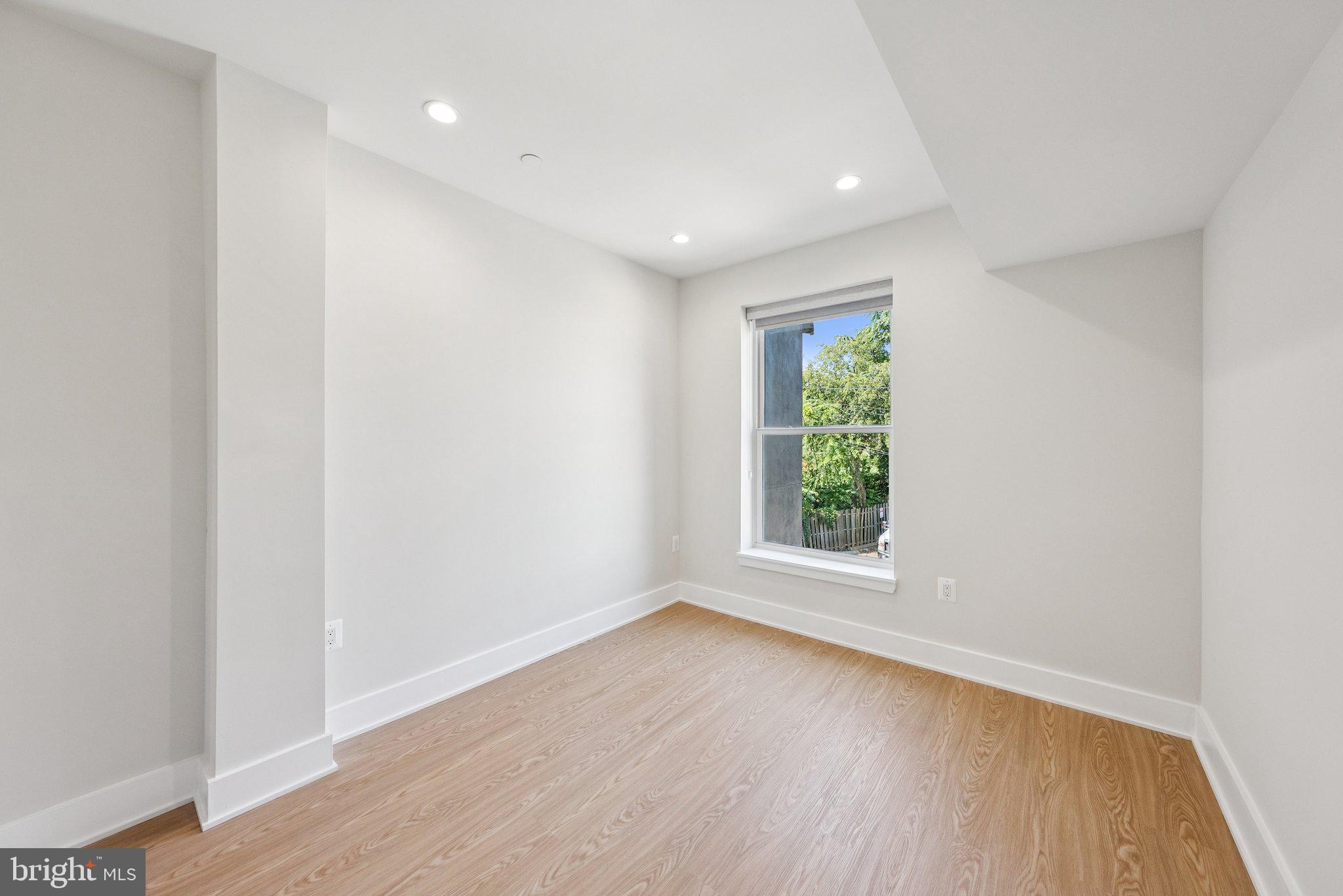 2134 Wisconsin Avenue Northwest, Unit 6 Washington, DC 20007 - Photo 16 of 40 an empty room with wooden floor and window