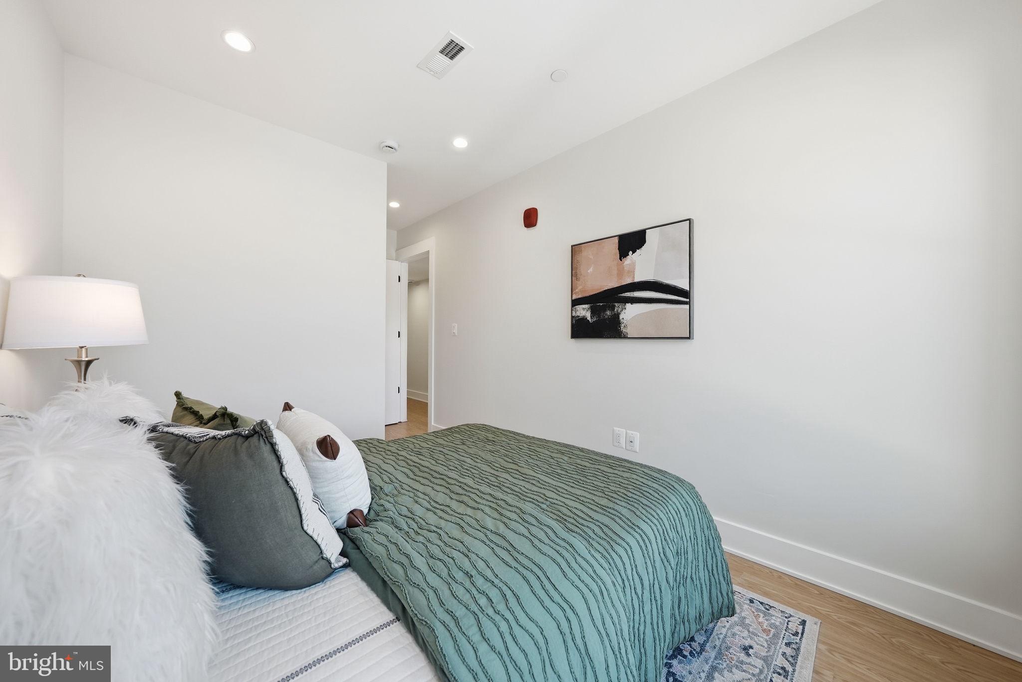 2134 Wisconsin Avenue Northwest, Unit 6 Washington, DC 20007 - Photo 17 of 43 a bedroom with a bed and a lamp