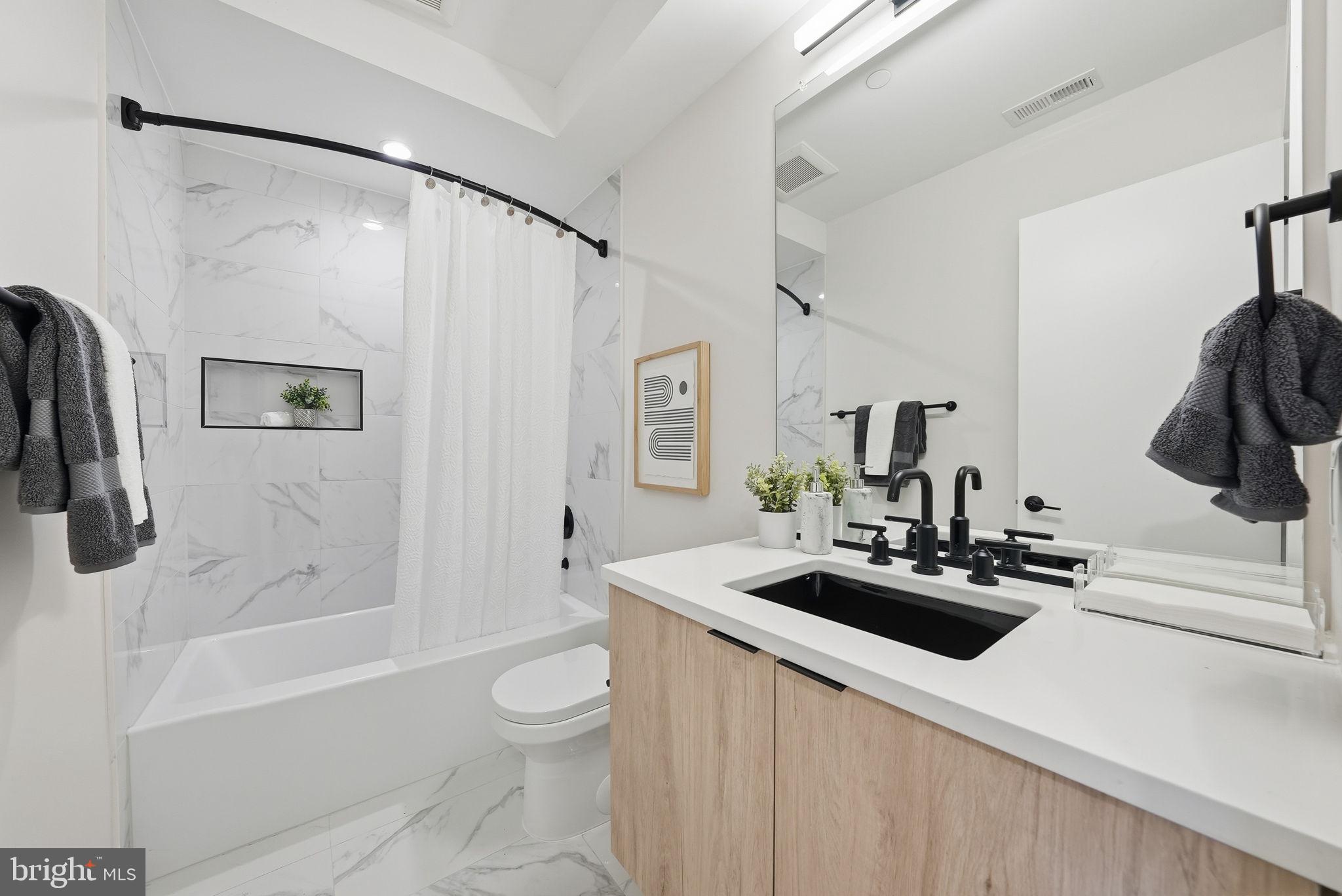 2134 Wisconsin Avenue Northwest, Unit 6 Washington, DC 20007 - Photo 18 of 43 a bathroom with a sink a toilet and a bathtub