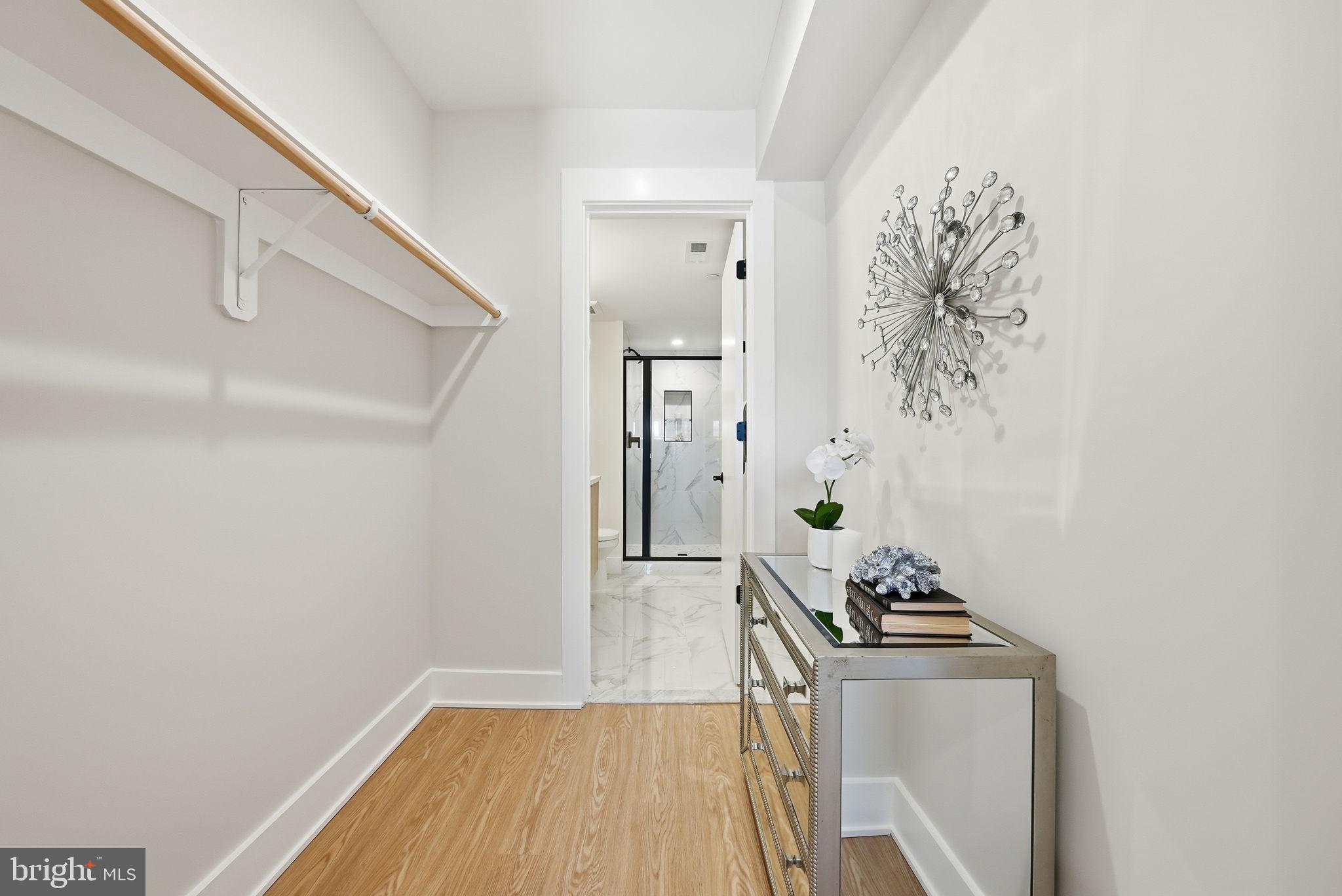 2134 Wisconsin Avenue Northwest, Unit 6 Washington, DC 20007 - Photo 19 of 43 a living room with a wooden floor and white walls