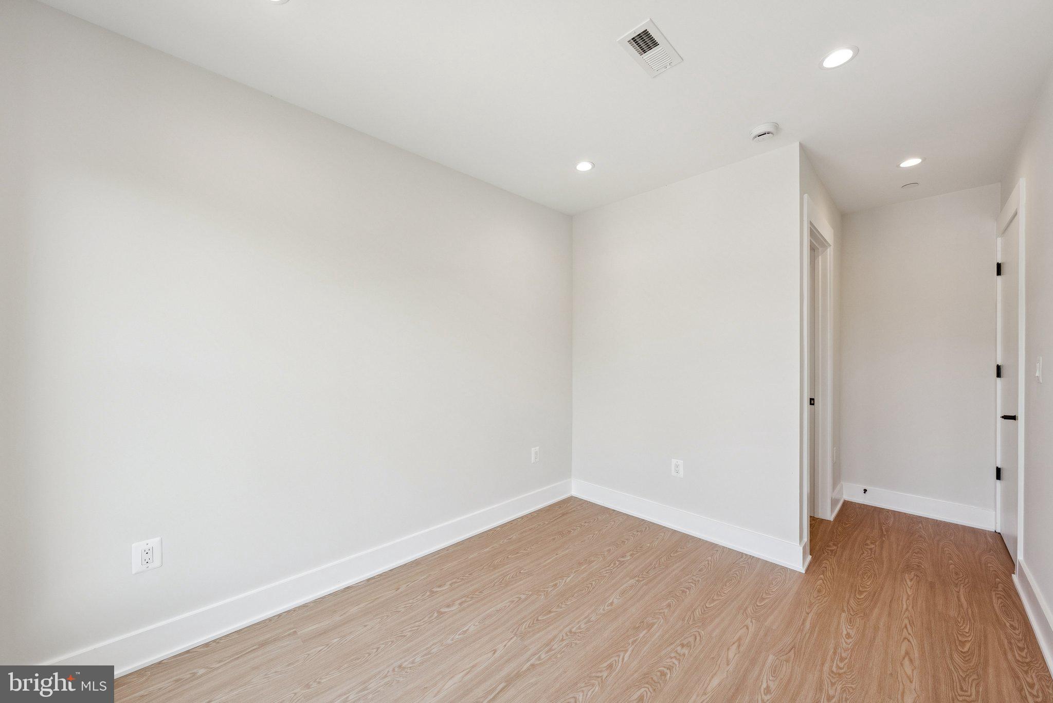 2134 Wisconsin Avenue Northwest, Unit 6 Washington, DC 20007 - Photo 20 of 40 a view of an empty room with wooden floor and a window
