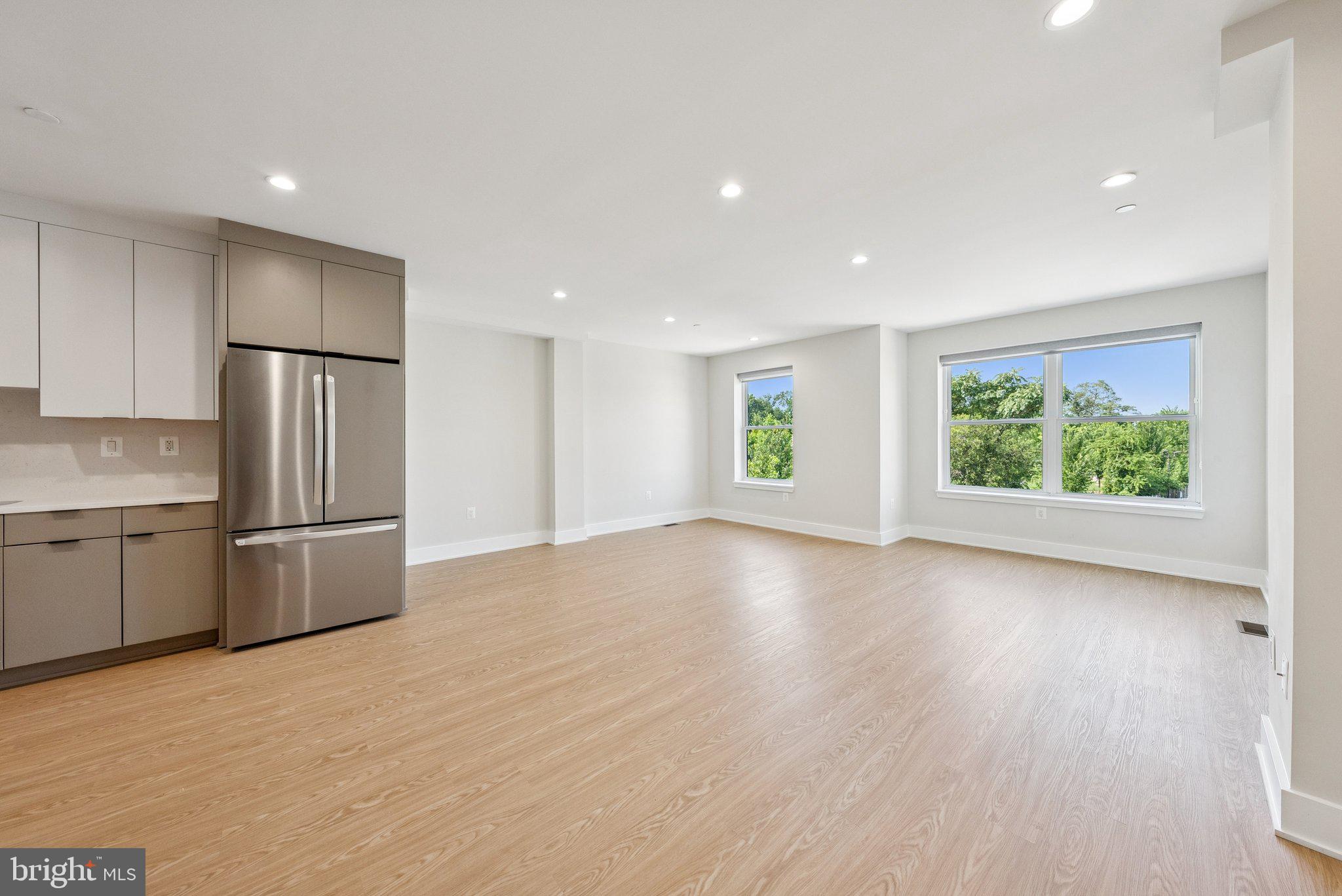 2134 Wisconsin Avenue Northwest, Unit 6 Washington, DC 20007 - Photo 2 of 40 a view of a kitchen with a stove top oven a sink and a refrigerator