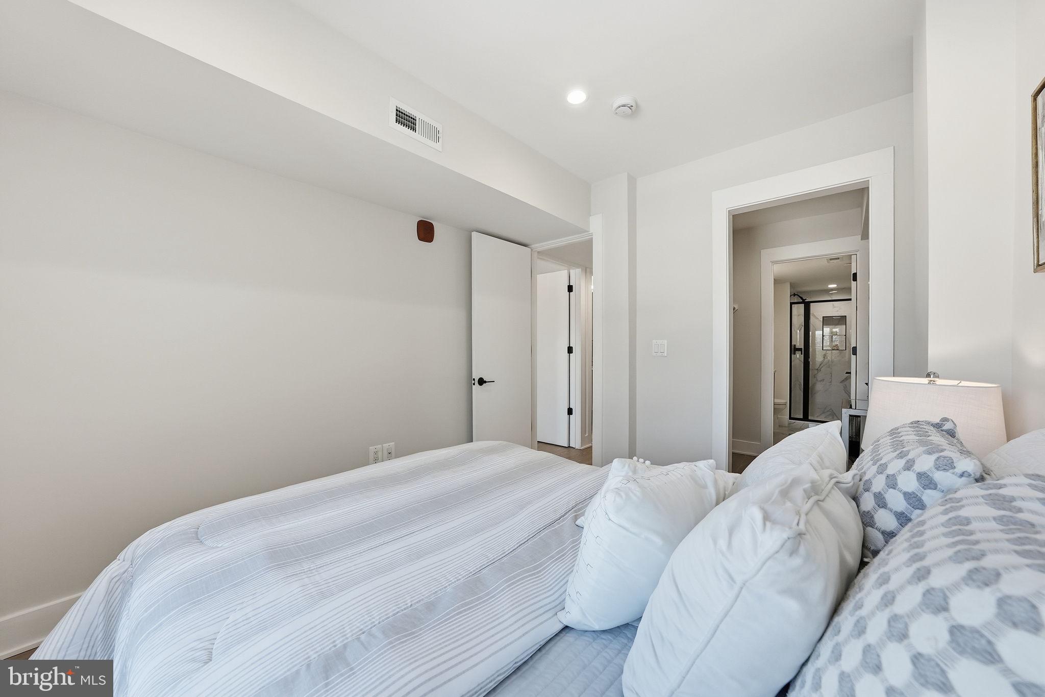 2134 Wisconsin Avenue Northwest, Unit 6 Washington, DC 20007 - Photo 22 of 43 a bedroom with a bed and a mirror