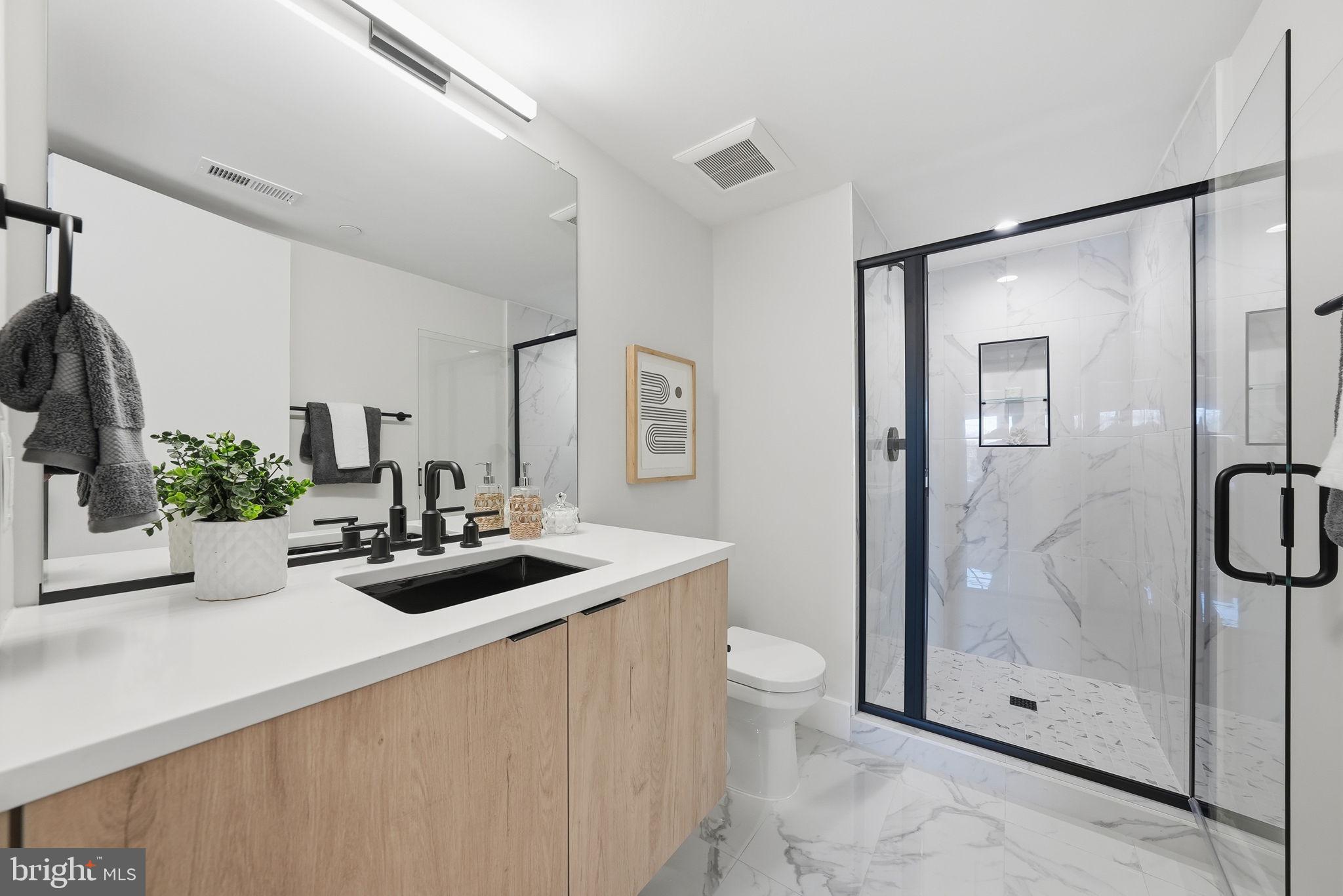 2134 Wisconsin Avenue Northwest, Unit 6 Washington, DC 20007 - Photo 23 of 43 a bathroom with a sink a toilet and shower