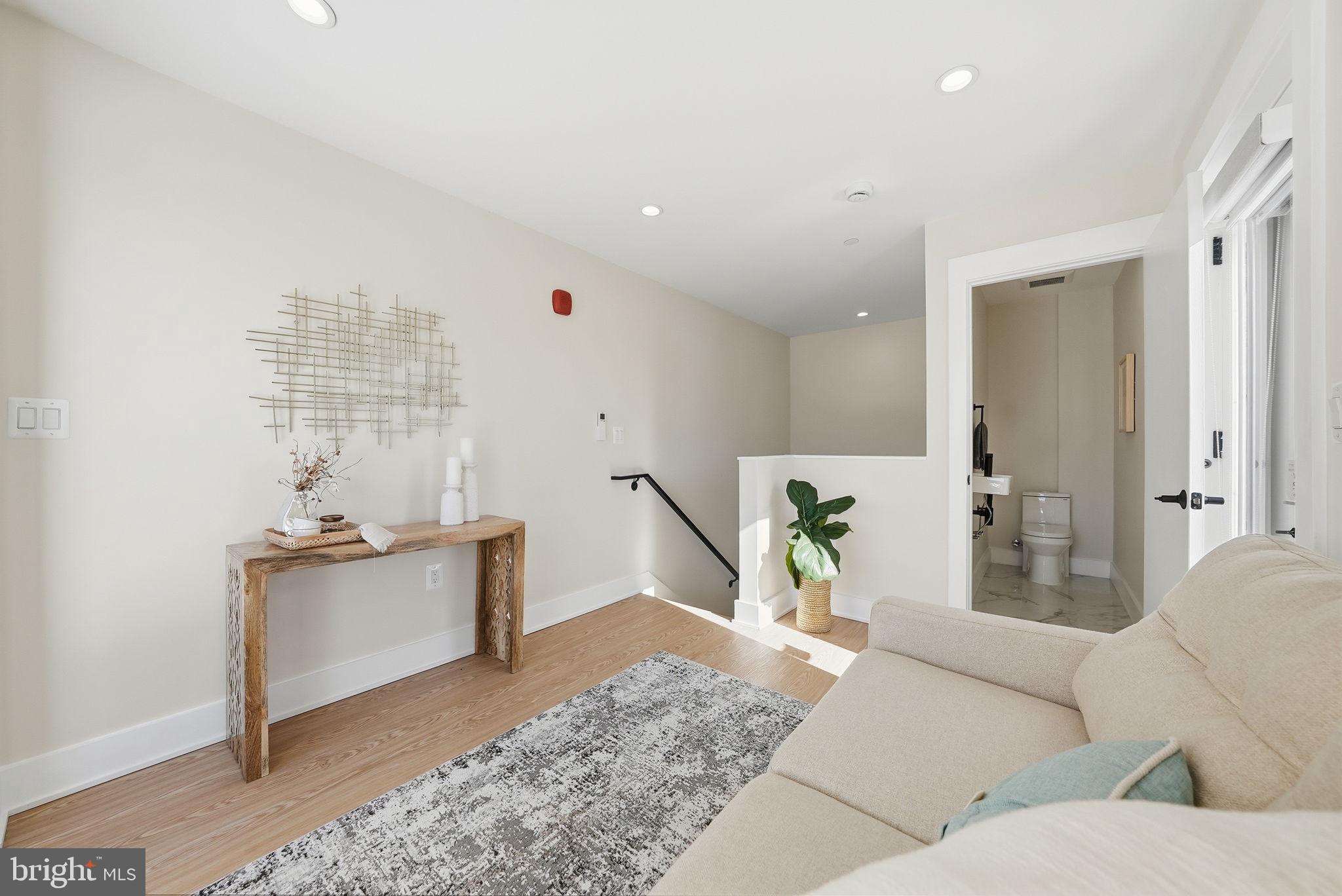 2134 Wisconsin Avenue Northwest, Unit 6 Washington, DC 20007 - Photo 24 of 43 a living room with furniture and a couch