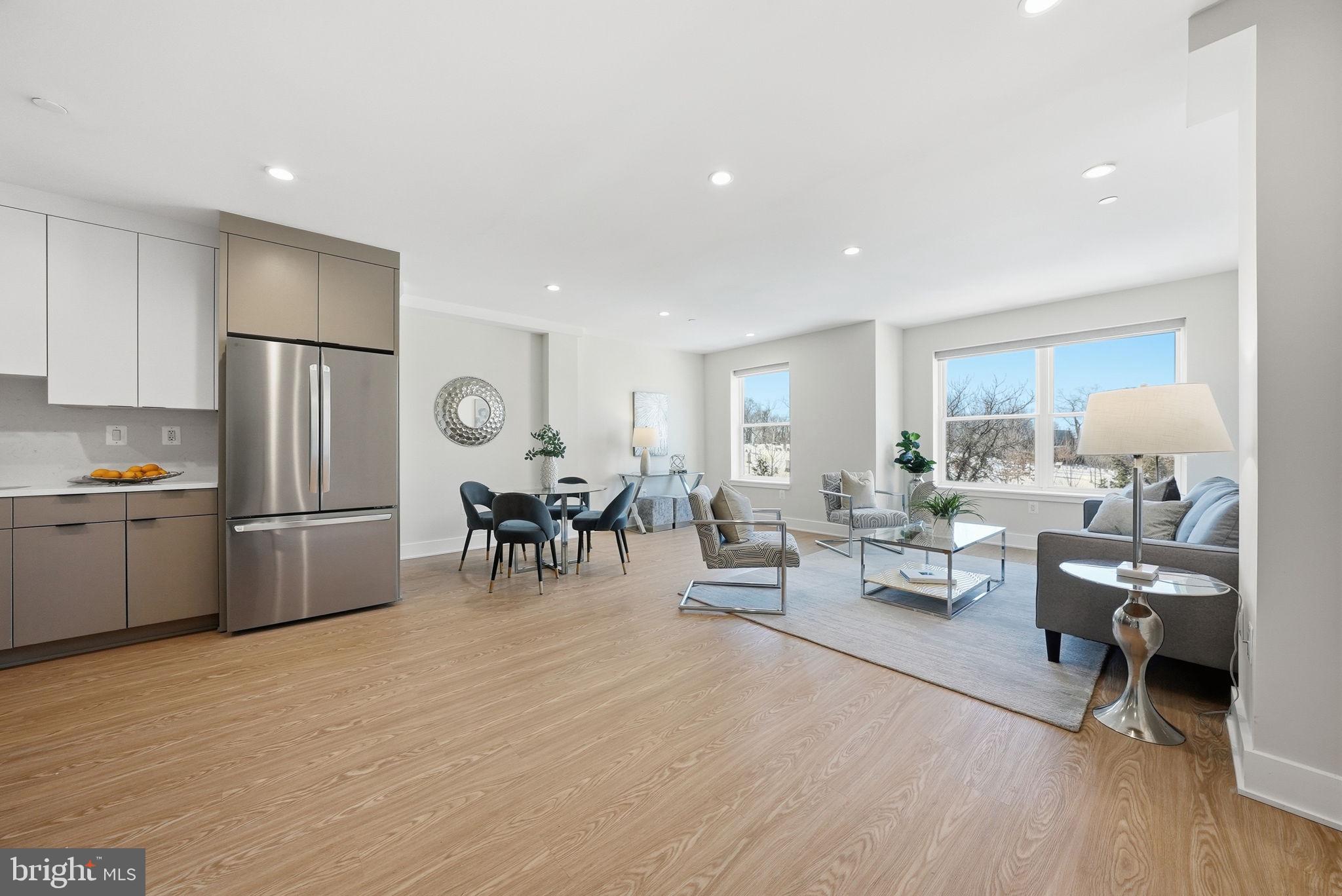 2134 Wisconsin Avenue Northwest, Unit 6 Washington, DC 20007 - Photo 3 of 43 a living room with furniture and a dining table with kitchen view