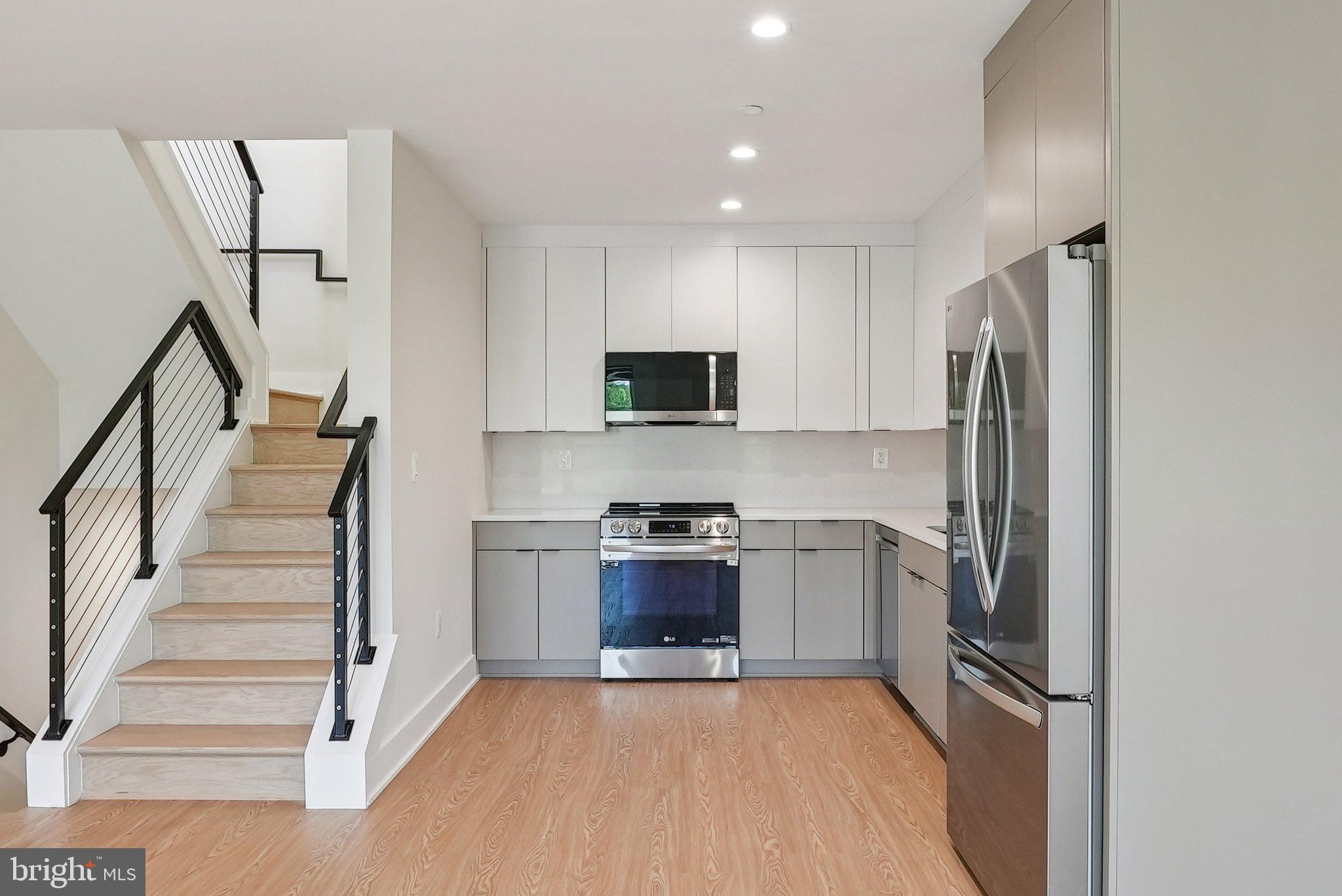 2134 Wisconsin Avenue Northwest, Unit 6 Washington, DC 20007 - Photo 3 of 40 a kitchen with granite countertop stainless steel appliances and a refrigerator