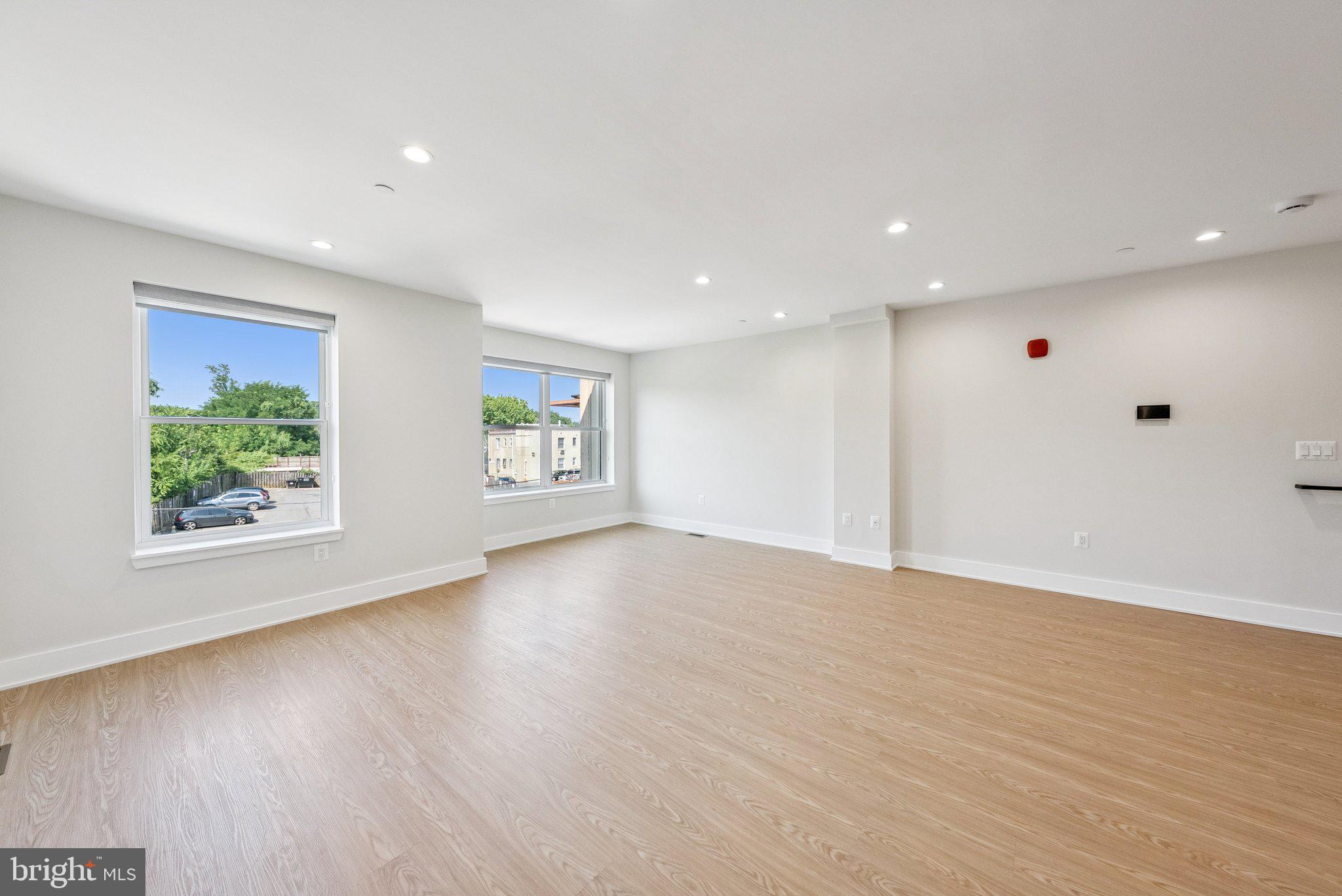 2134 Wisconsin Avenue Northwest, Unit 6 Washington, DC 20007 - Photo 9 of 40 a view of an empty room with wooden floor and a window