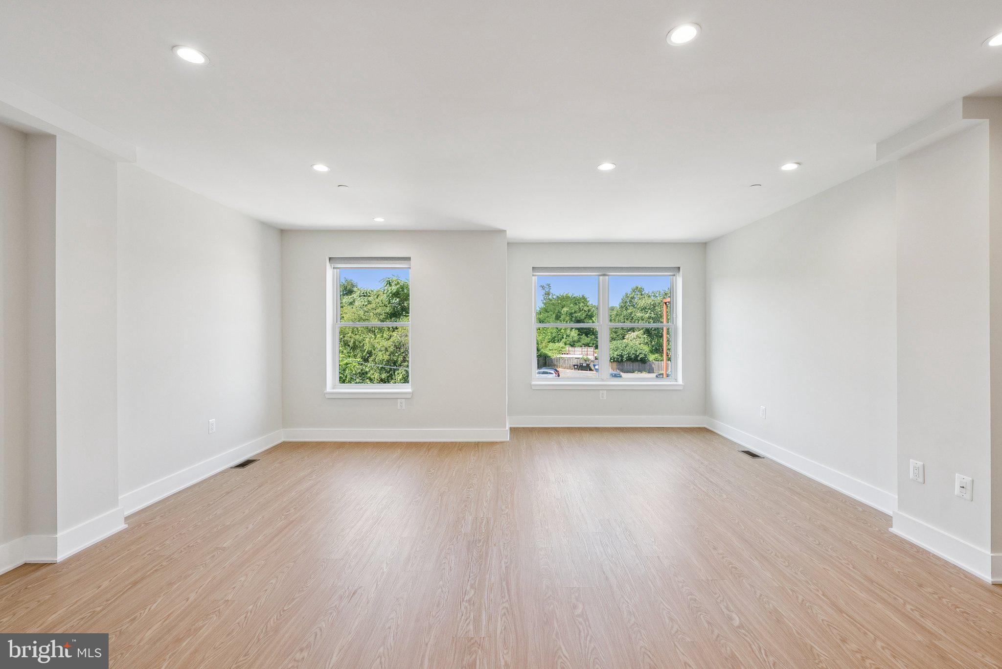2134 Wisconsin Avenue Northwest, Unit 6 Washington, DC 20007 - Photo 10 of 40 an empty room with wooden floor and windows