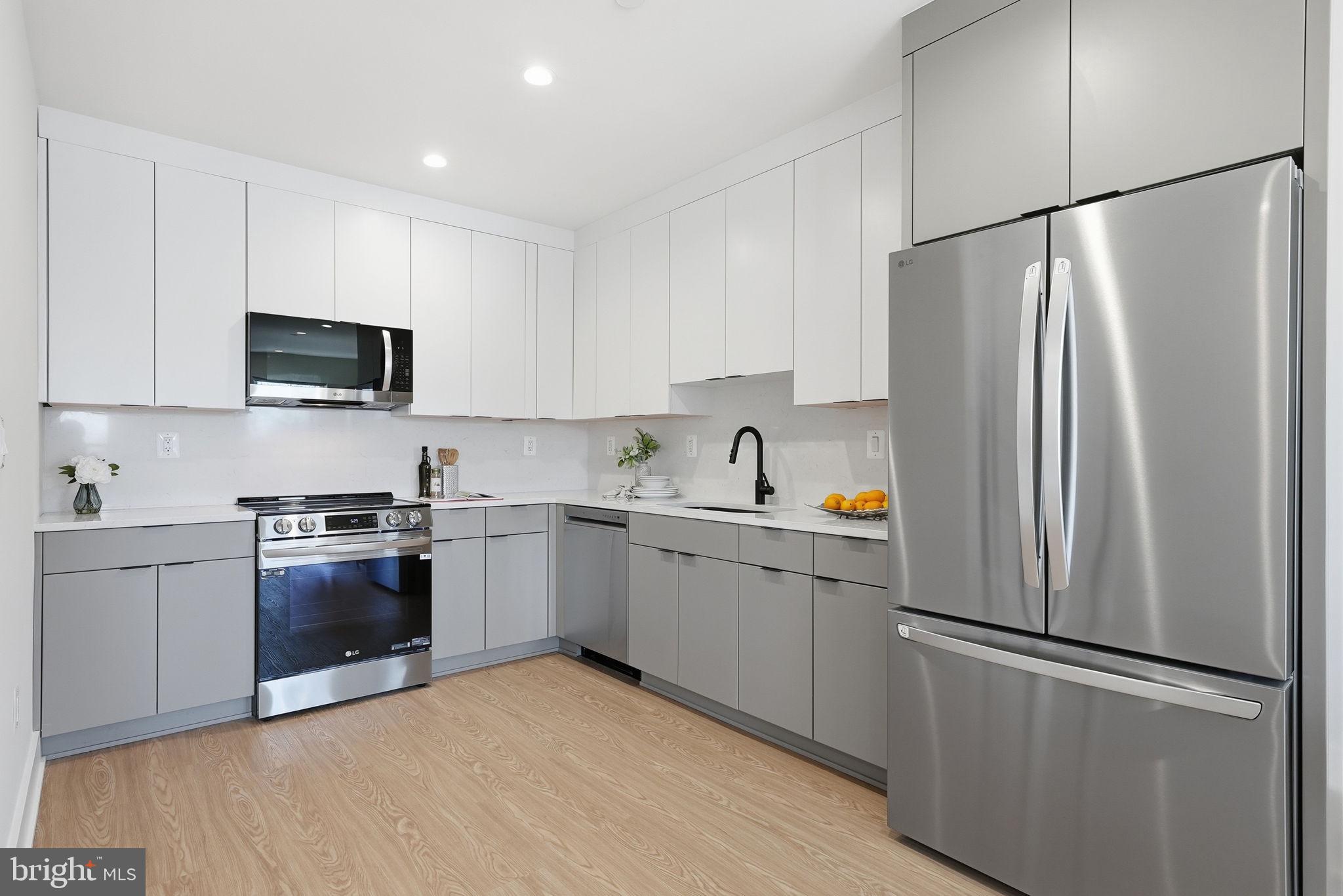 2134 Wisconsin Avenue Northwest, Unit 6 Washington, DC 20007 - Photo 10 of 43 a kitchen with a refrigerator and a stove top oven